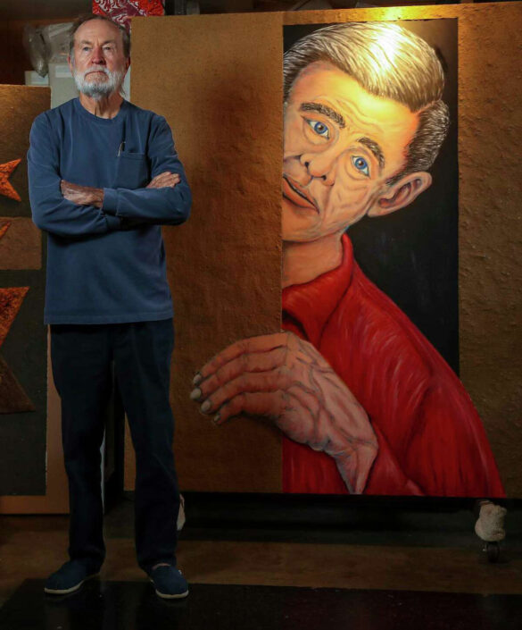 A photograph of artist Wayne Gilbert in his home studio.